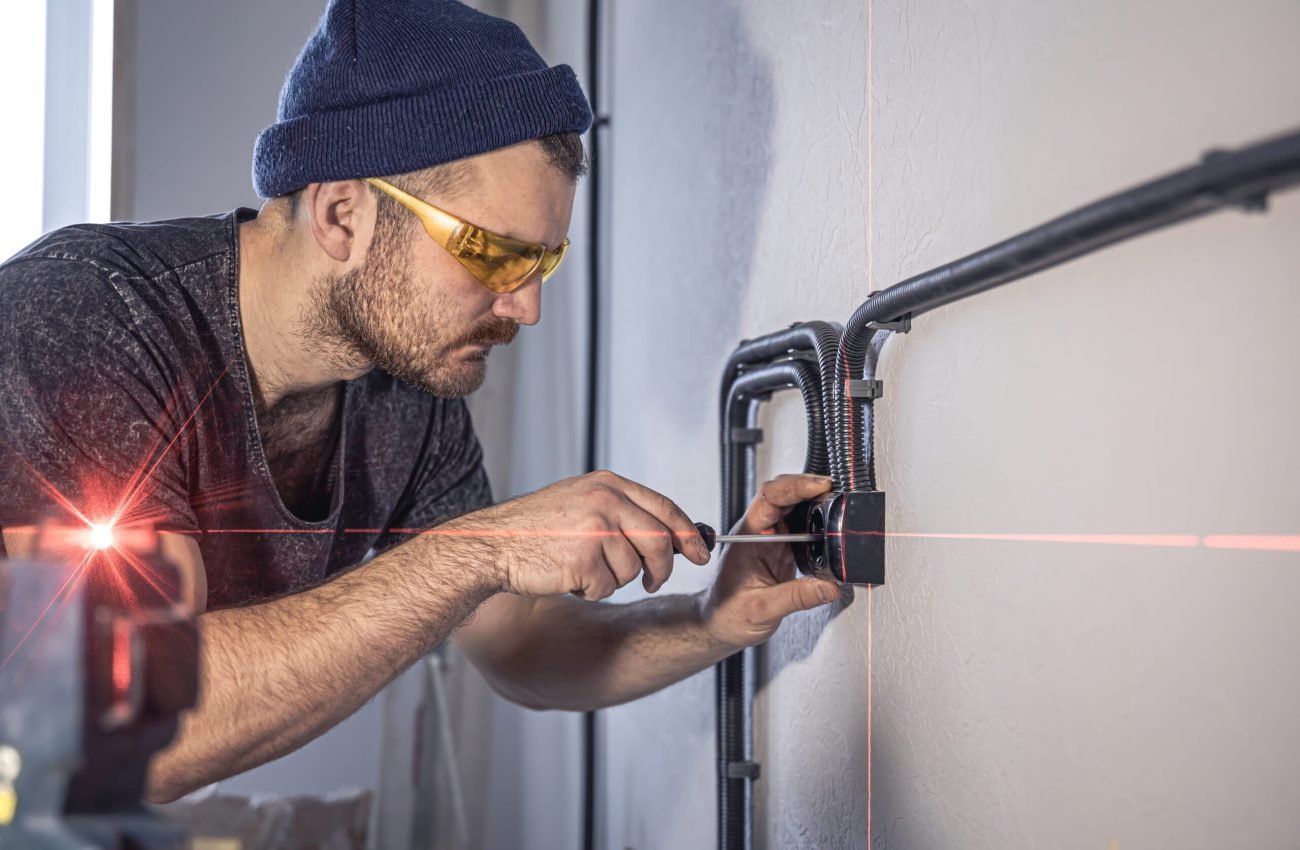 electrician-is-mounting-electric-sockets-white-wall-indoors (1)